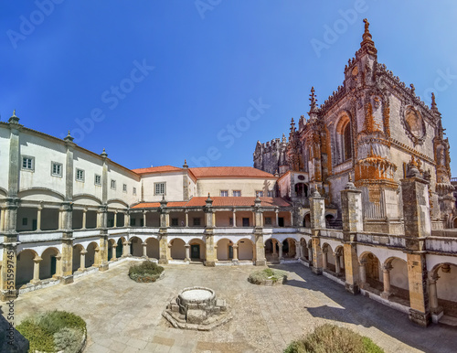 View at the Hospedaria cloister, Lodging cloister, Charola gothic main building as background, tourist people visiting, UNESCO heritage building Convent of Christ, Tomar