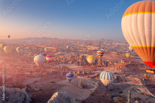 Beautiful romantic sunrise landscape in Cappadocia with colorful hot air balloon deep canyons, valleys from aerial view. Concept banner travel Turkey