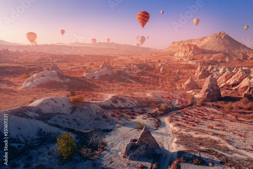 Panoramic view of Goreme national park with over deep canyons, valleys sunset Cappadocia sunset with hot air balloons