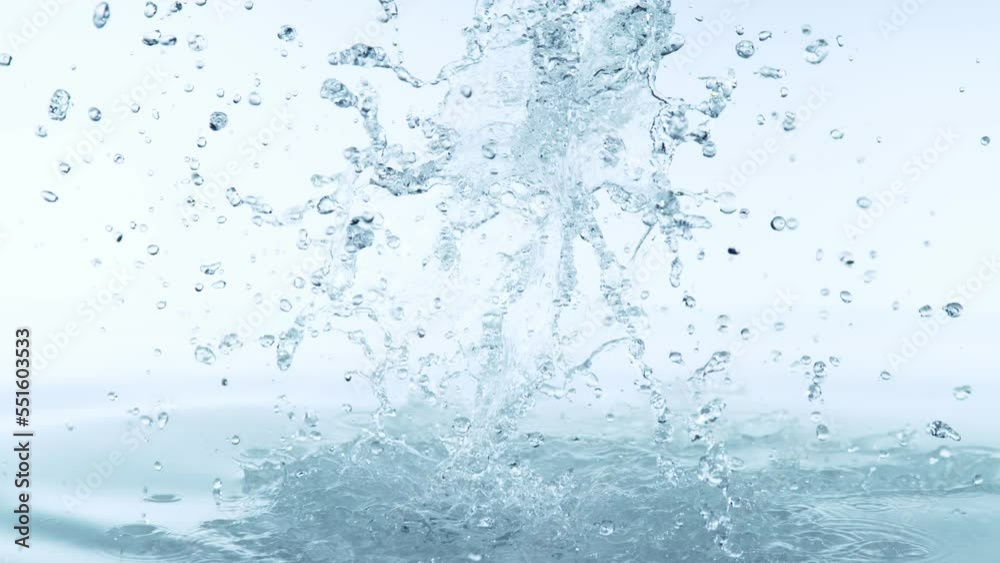Super slow motion of splashing water isolated on blue background. Filmed on high speed cinema camera, 1000fps. Speed ramp effect. Super slow motion of splashing water isolated on blue background. Filmed on high speed cinema camera, 1000fps. Speed ramp effect.