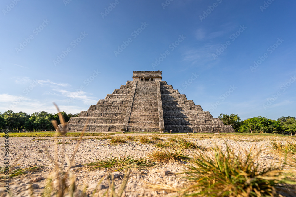Photo of the pyramid in Chichen Itza taken through the plants. Photo of the pyramid in Chichen Itza taken through the plants.