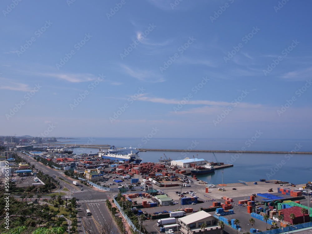 Cargo ships are moored in the port to load cargoes
