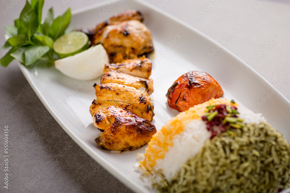 Jujeh chhicken tikka boti kabab with rice and salad served in dish isolated on grey background top view of arabic food
