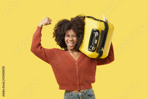 African American young woman in casual lifestyle with yellow luggage is look exciting and ready to travel. 