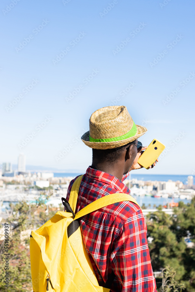 Unrecognizable young African taking a selfie at a viewpoint in Barcelona (Spain).