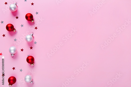 Creative holiday pattern. Christmas background of red and white baubles on a pink background.