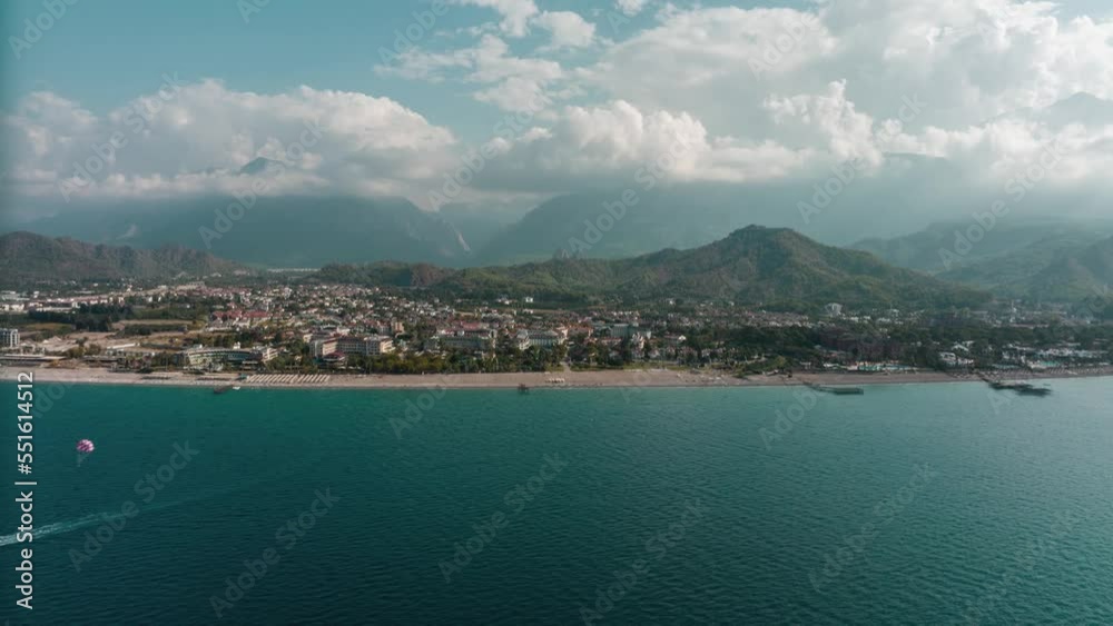 View from the sea to the coastal city. Sunny day. Green mountains. Drone video 4k footage. Landscape. Coastline. Boats. View from the sea to the coastal city. Sunny day. Green mountains. Drone video 4k footage. Landscape. Coastline. Boats.