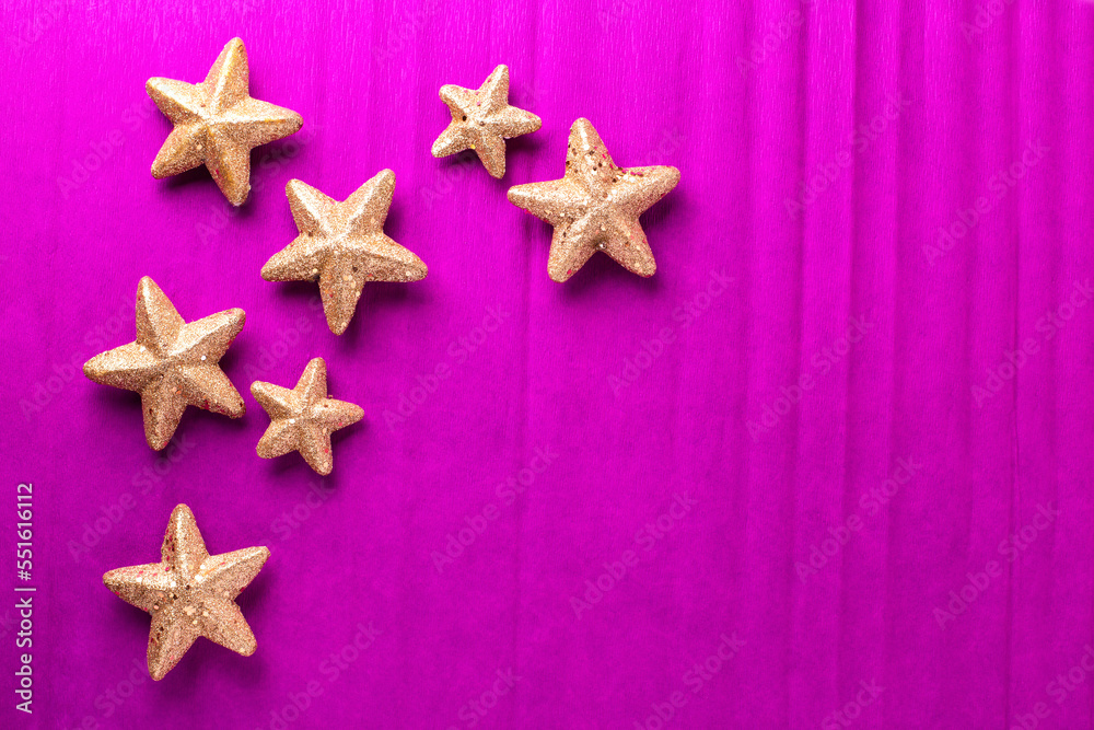 Postcard with big and small golden decorative stars on bright pink paper textured background. Top view. Christmas, New Year holidays concept. Place for text. Postcard with big and small golden decorative stars on bright pink paper textured background. Top view. Christmas, New Year holidays concept. Place for text.
