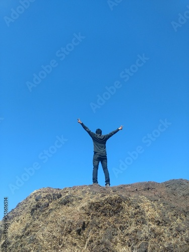 person on the top of the mountain