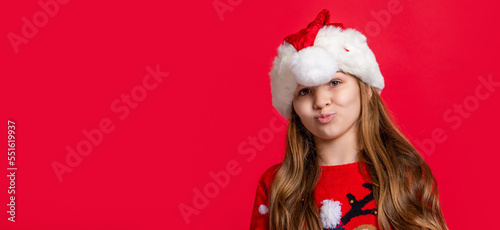 teen girl wear sweater and santa hat at new year holiday, copy space. happy new year.