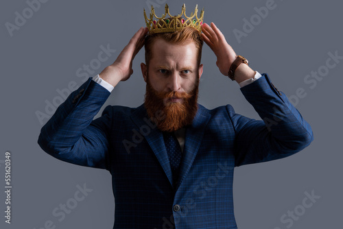 Irish man egoist wearing crown. Crowned businessman. Selfish successful businessman photo