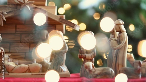 Olive Tree Wood Nativity With Hand Putting Baby Jesus Into Manger