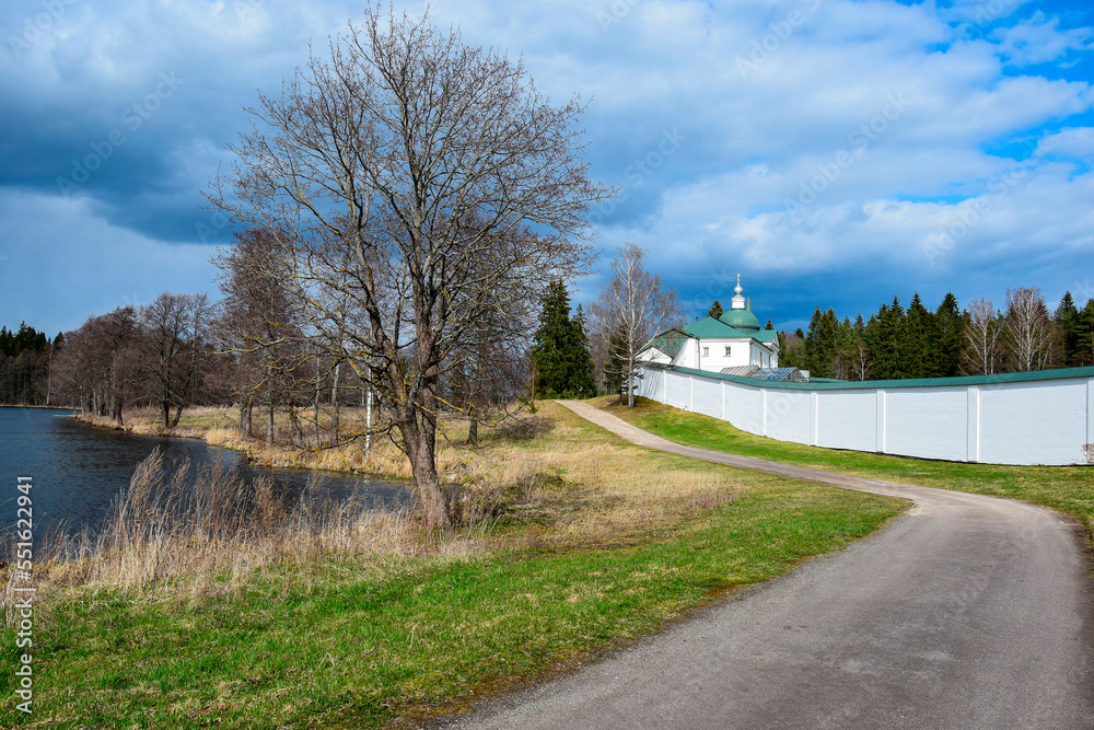 Landscape photo with a road along the Orthodox monastery