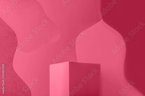 Podium or platform for product presentation with Curved background toned in viva magenta color of the year 2023. Solid Display Block for Shop Windows, geometric stand for cosmetics