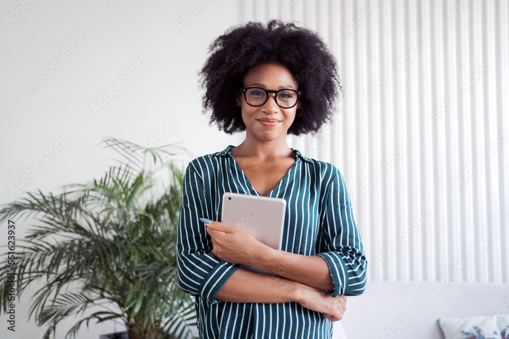A smart freelancer woman with glasses uses a tablet to make a report online.  Manager in business glasses for computer.