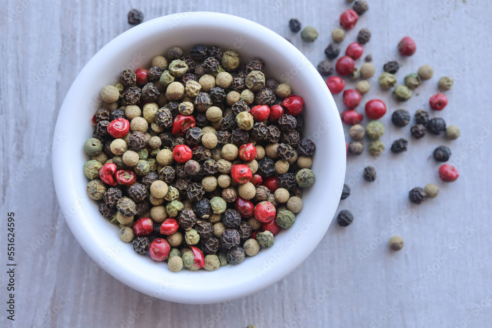 Mixed peppercorns in a wooden bowl Mixed peppercorns in a wooden bowl