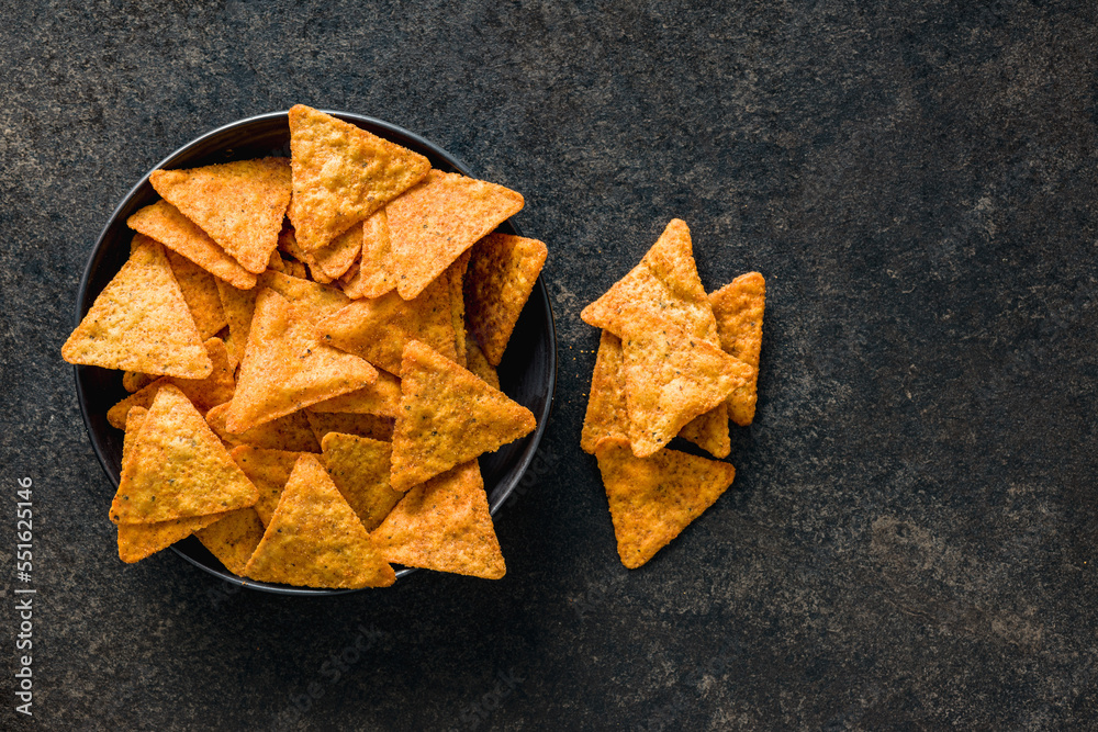 Tortilla chips with the flavor of chili peppers on plate. Top view. Tortilla chips with the flavor of chili peppers on plate. Top view.