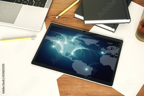 Top view of modern digital tablet monitor with abstract world map with connections  research and strategy concept. 3D Rendering
