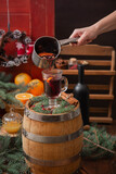The process of pouring mulled wine into a glass from a saucepan