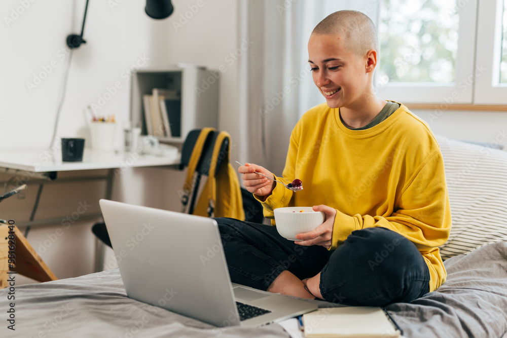 College student has breakfast in bed and attends online class College student has breakfast in bed and attends online class