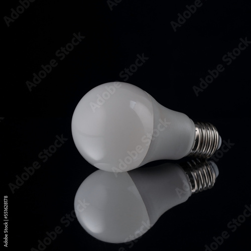 economical white light bulb on black background