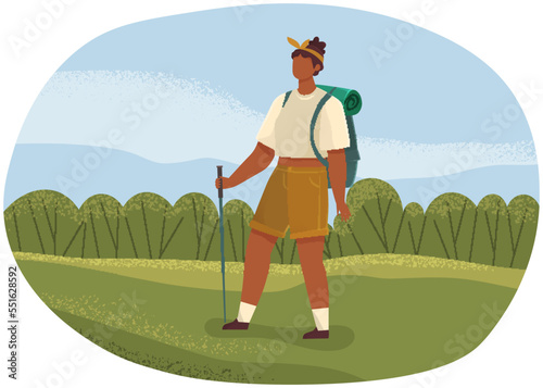 Female tourist with backpack and hiking stick walking. Outdoor travelling and nature camping. Woman traveler on trip, girl stands on green lawn. Tracking through mountains and trails, adventure time