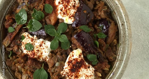 Aubergine and puy lentils stew with Greek yoghurt, fresh oregano leaves and Ethiopian berbere spice blend close-up. photo