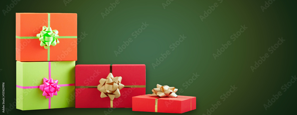 Christmas banner with many red gift boxes tied golden ribbons on green XMas background. Happy New 2023 Year and christmas gift border with free copy space for text