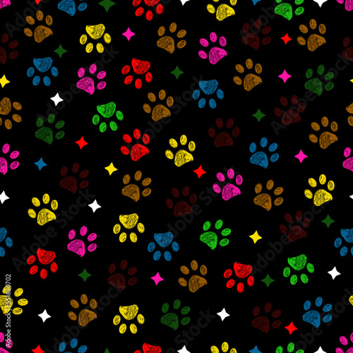 Colorful paw prints with stars seamless fabric design pattern with dark background