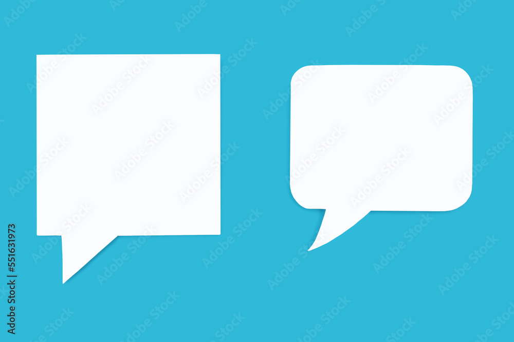 Paper speech bubbles of different shapes on a blue background. Flat white chat icons in the form of empty speech bubbles. Free space for text or image. The concept of communication in the modern world Paper speech bubbles of different shapes on a blue background. Flat white chat icons in the form of empty speech bubbles. Free space for text or image. The concept of communication in the modern world