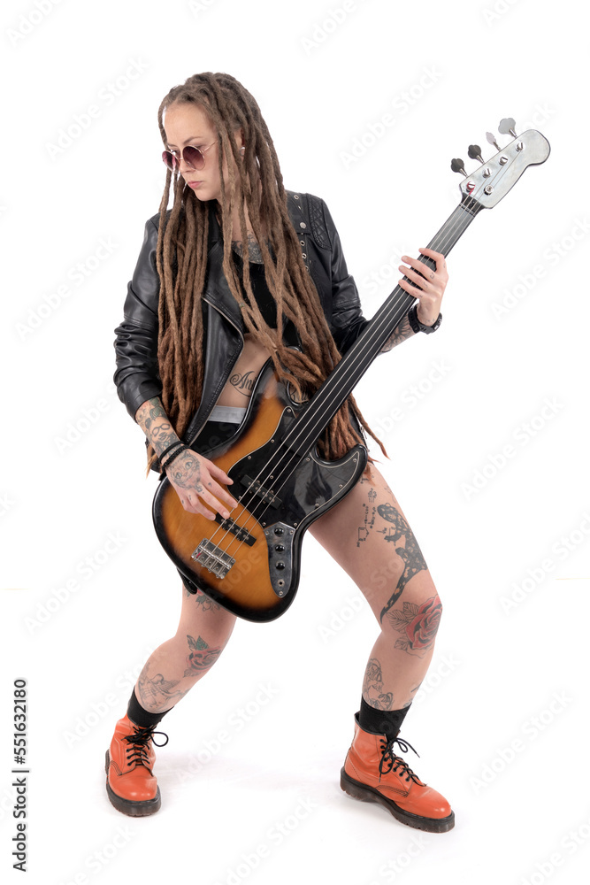 Woman with a bass guitar. Long dreadlocks. Tattoos all over the body Woman with a bass guitar. Long dreadlocks. Tattoos all over the body