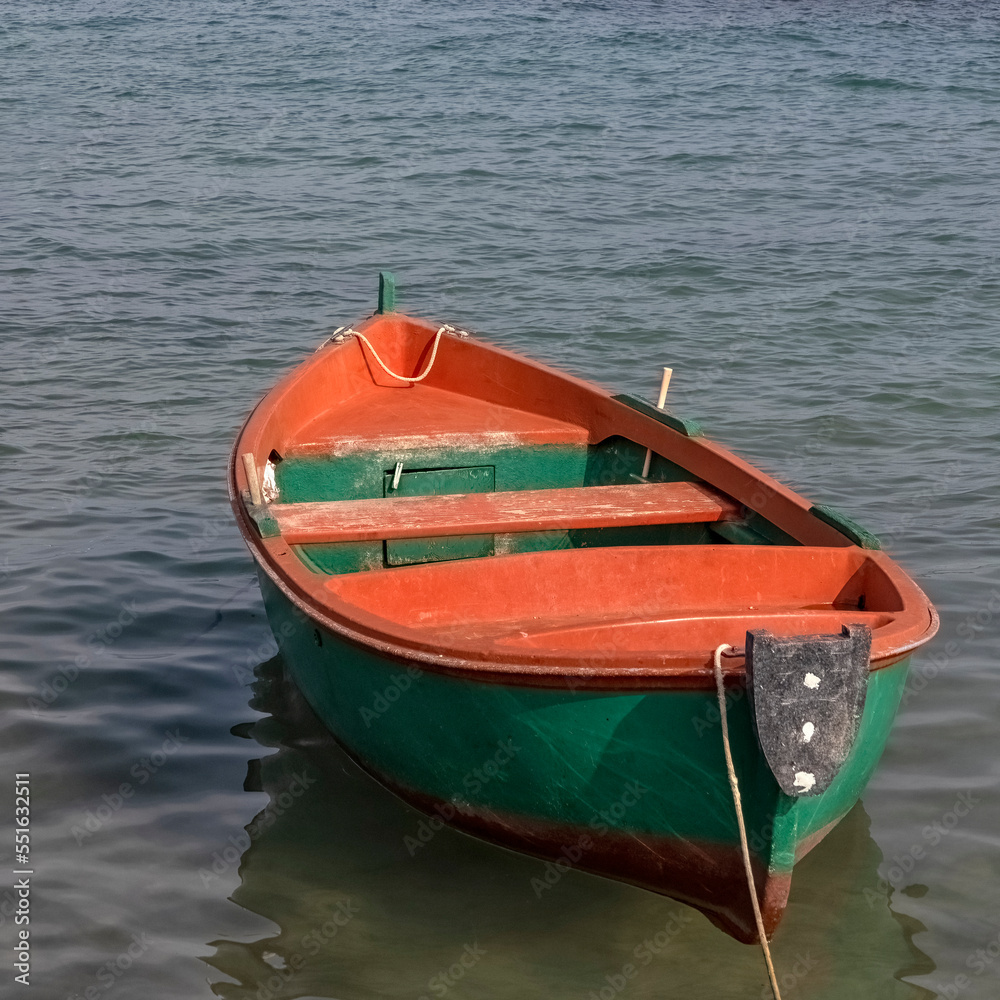 Traditional wooden fishing boat with green hull and red interior