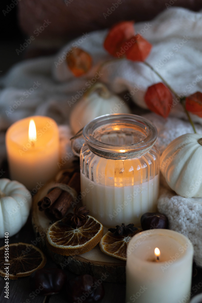 Autumn home composition with aromatic candle, dry citrus, cinnamon, anise. Aromatherapy on a grey fall morning, atmosphere of cosiness and relax. Wooden background close up Autumn home composition with aromatic candle, dry citrus, cinnamon, anise. Aromatherapy on a grey fall morning, atmosphere of cosiness and relax. Wooden background close up