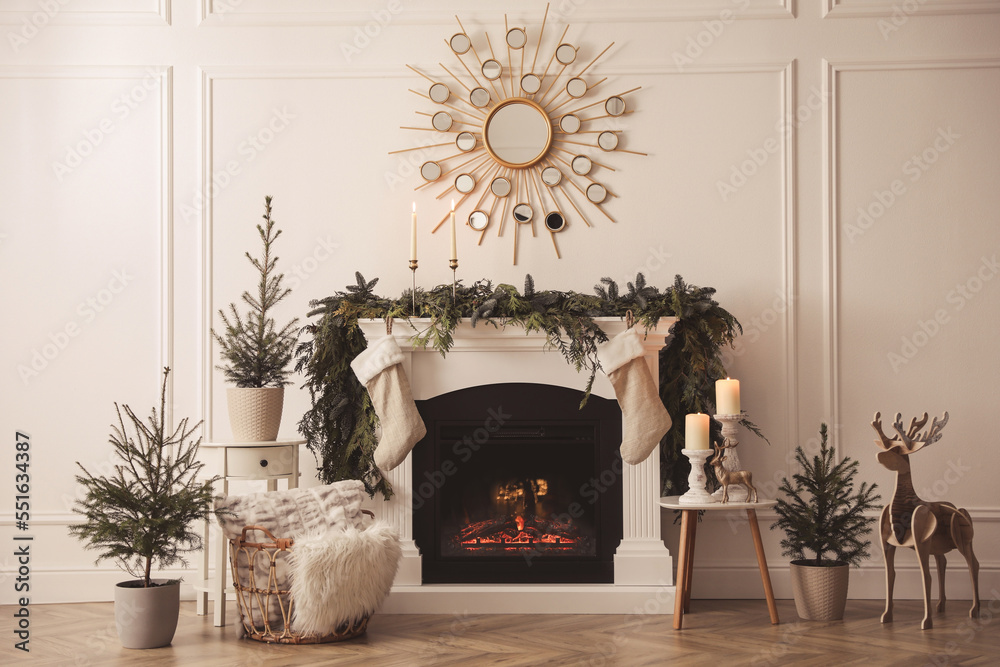 Fototapeta premium Stylish room interior with fireplace and beautiful Christmas decor