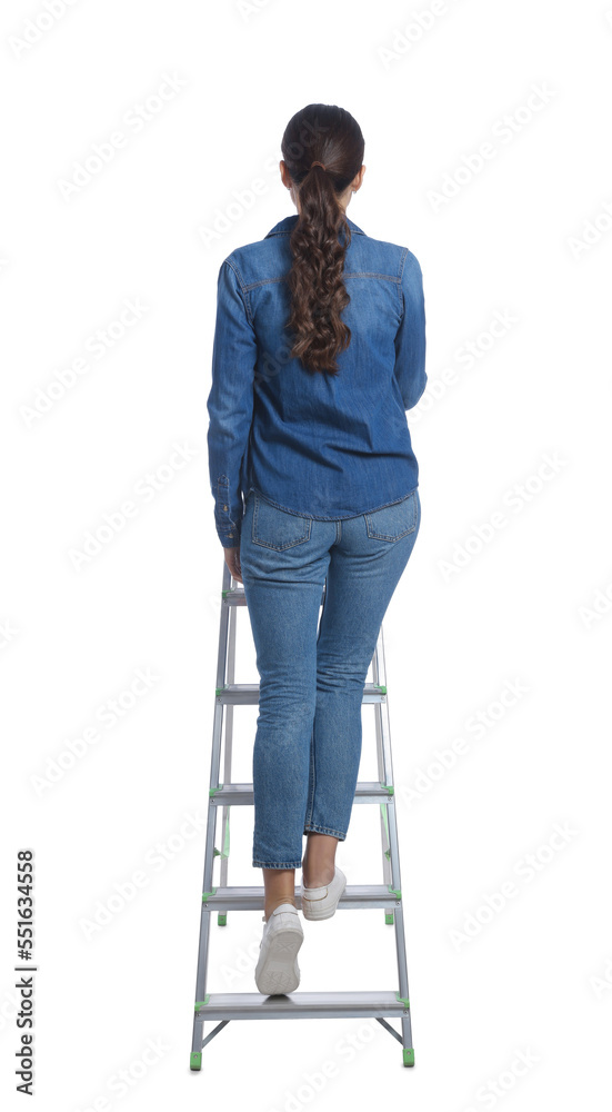 Young woman climbing up metal ladder on white background, back view