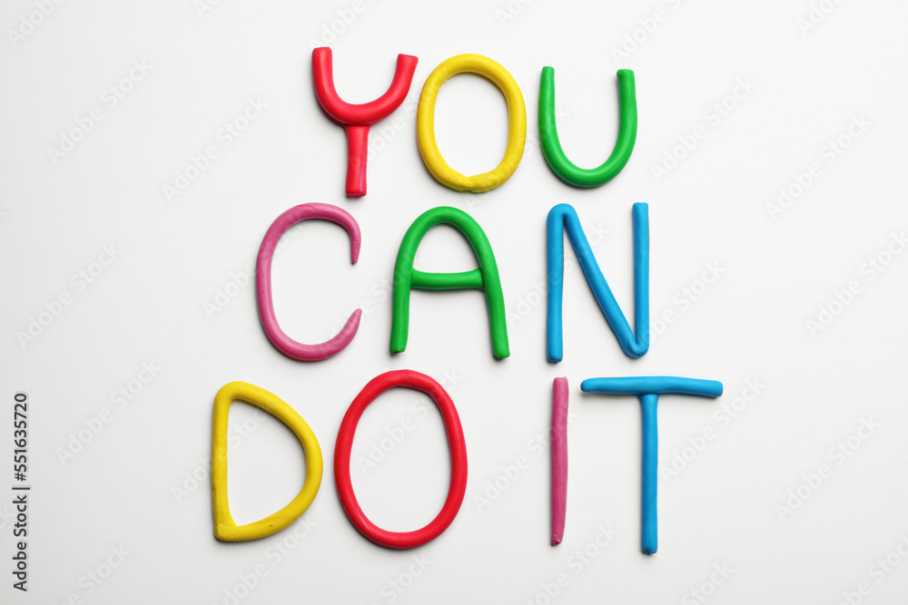 Motivational phrase You Can Do IT made of colorful plasticine on white background, flat lay