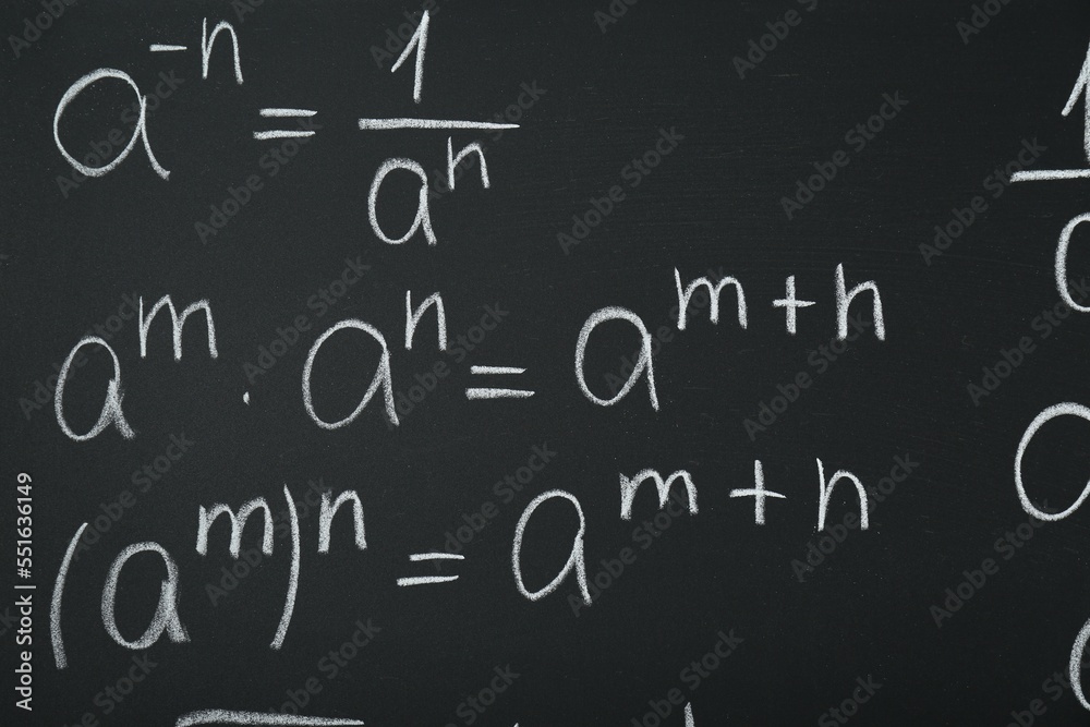 Many different math formulas written on chalkboard, closeup Many different math formulas written on chalkboard, closeup