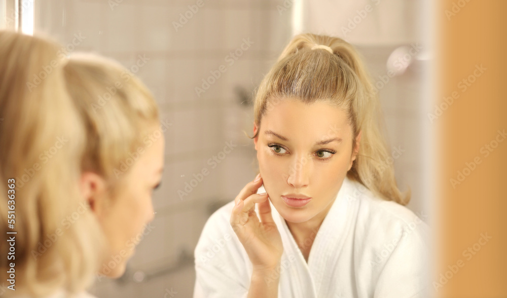 Woman looking in the mirror Applying the cream..Magic anti-aging cream Woman looking in the mirror Applying the cream..Magic anti-aging cream