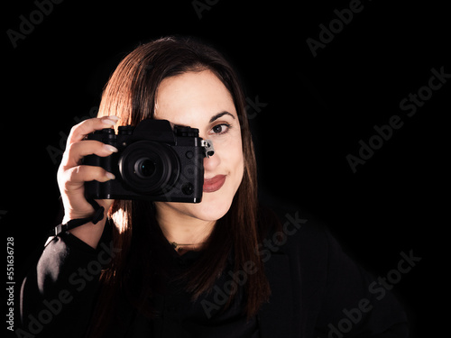 woman photographer close up camera on black background 