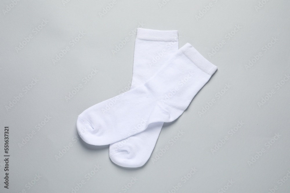 Pair of white socks on light grey background, flat lay Pair of white socks on light grey background, flat lay