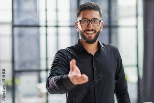 Businessman ready to shake hand in office