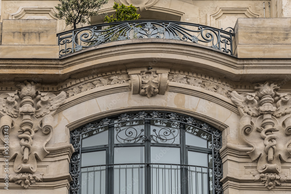 Traditional old French house: balconies and windows. Paris, France.