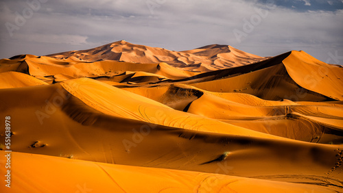 Sahara Desert sand dunes background. Popular travel destination, Erg Chebbi, Sahara Desert, Morocco. photo