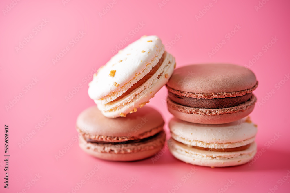 Sweet multicoloured macarons on a bright background