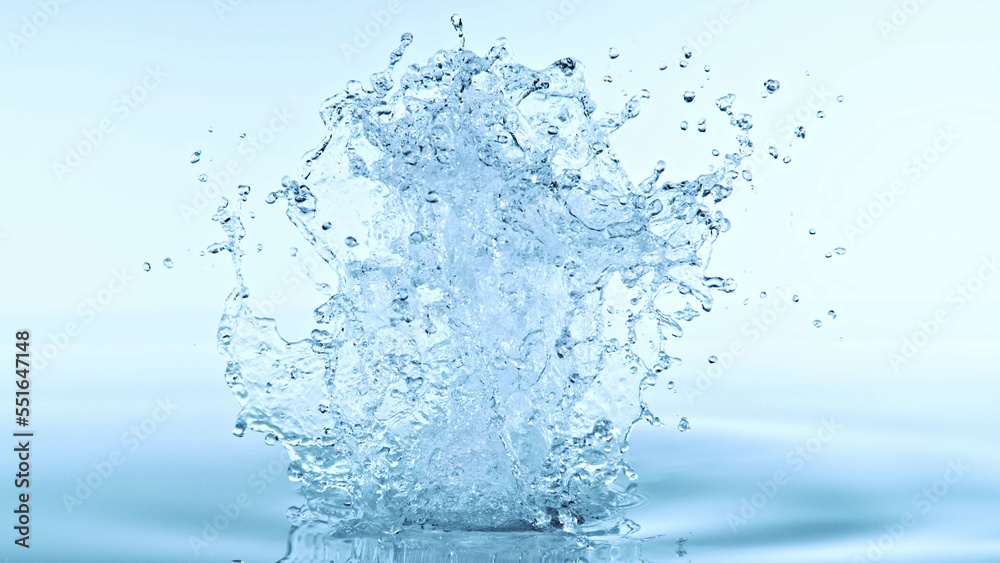 Water splash isolated on soft blue background.