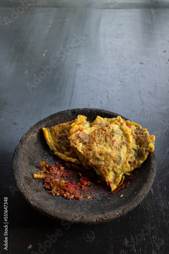 Omelet served with red chili sauce