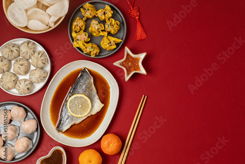 Chinese new year festival table over red background. Traditional lunar new year food. Flat lay, top view