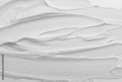 Samples of face cream as background, top view