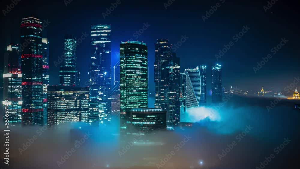 Moscow City business center skyscrapers office buildings and luxury apartments timelapse with fog at night. Moscow city towers panorama from above. Modern european architecture