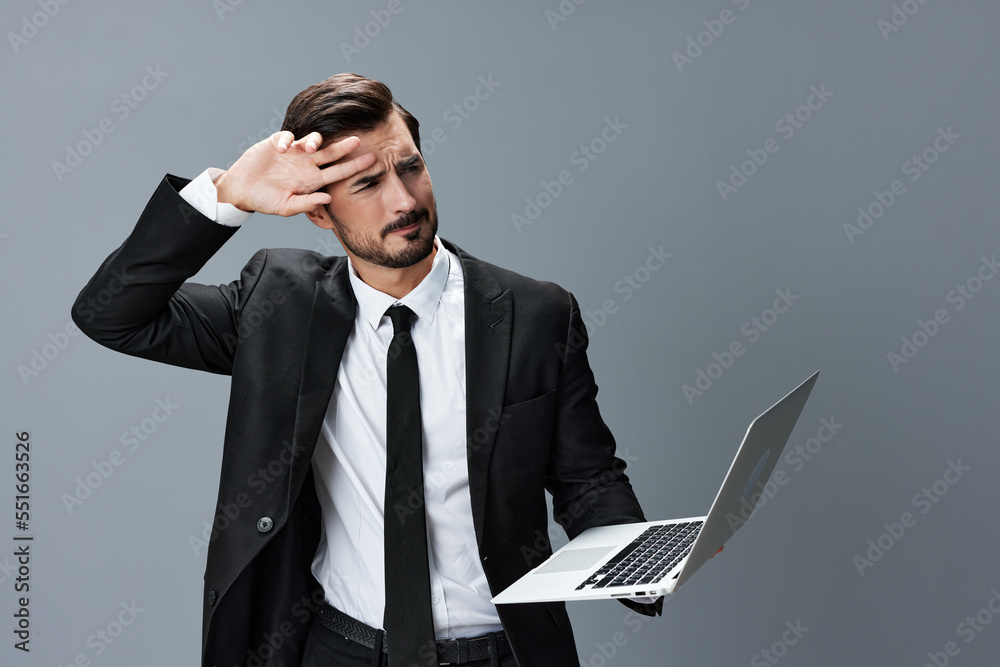 Man business with headache and anger business negotiation screams online internet by video call on gray background. Sadness and failure to cooperate Man business with headache and anger business negotiation screams online internet by video call on gray background. Sadness and failure to cooperate